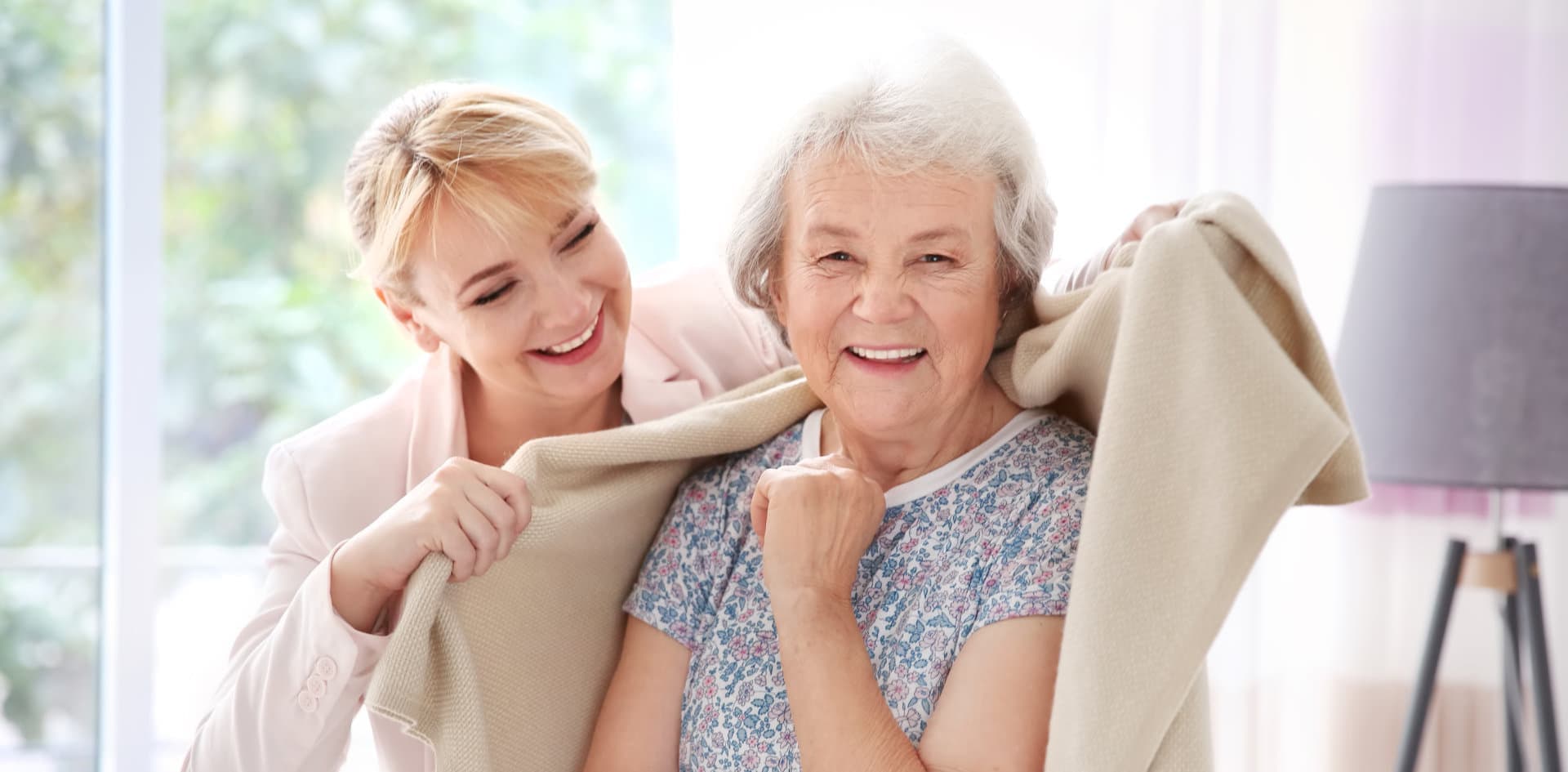 caregiver giving a towel to her patient