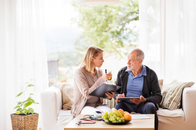 adult woman and senior man talking about medicine